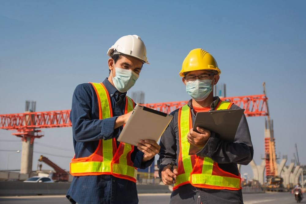Field workers wearing safety gear